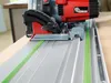 A close-up view of a circular saw on a track guide. Voir les images du produit