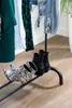A clothing rack with shoes on the bottom shelf. Náhľad obrázku produktu