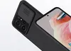 A close-up shot of a black smartphone case with a sliding camera cover, showing the camera module and part of the phone screen. Náhled obrázku produktu