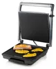 An open electric grill with food cooking on it. Podgląd zdjęcia produktu