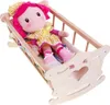 A doll is lying in a wooden cradle. Náhľad obrázku produktu