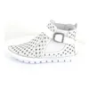 A white leather bootie with a perforated design and a buckle strap. Produktbild-Vorschau