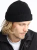 A man wearing a black beanie and a black jacket. Produktbild-Vorschau