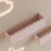 Two pink shelves with scalloped edges are mounted on a light beige wall. A white neon cloud light is partially visible in the upper left corner, and a white neon star light is partially visible in the bottom left corner. Produktbild-Vorschau