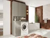 A modern bathroom with a washing machine cabinet, bathtub, and plant. Produktbild-Vorschau