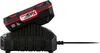 A black and red battery pack is shown charging on a black charging base. Produktbild-Vorschau