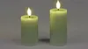 Two green LED candles with flickering flames are shown against a plain gray background. Produktbild-Vorschau