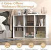 A white cube bookshelf is shown in a bedroom setting, next to a bed. The bookshelf is filled with decorative items and books. Náhľad obrázku produktu