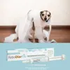 A dog wrapped in toilet paper is shown in the top half of the image, and the product packaging and syringe are shown in the bottom half. Produktbild-Vorschau
