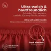 Close-up of red fabric with text overlays highlighting product features. Anteprima dell’immagine prodotto