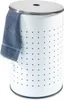 A white laundry hamper with a blue towel draped over the side.