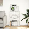A white bookshelf filled with decorative items and books, placed next to a sofa in a living room. Náhled obrázku produktu