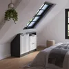 A bedroom with slanted ceilings, featuring a built-in wardrobe under a skylight and a bed. Voir les images du produit