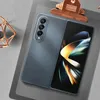 A folded smartphone is shown on a gray surface, with a copper clip and a decorative object in the background. Náhled obrázku produktu