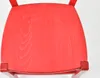 Close-up view of the seat of a red wooden chair. Voir les images du produit