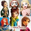 A collage of fondant figures, likely cake decorations, featuring various characters and a doll's face. Produktbild-Vorschau