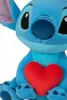 A close-up of a blue Stitch plush toy holding a red heart. Podgląd zdjęcia produktu