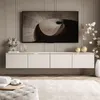 A modern living room with a wall-mounted TV cabinet and a large television. Produktbild-Vorschau