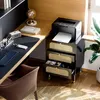 A home office setup with a desk, chair, and filing cabinet. Voir les images du produit