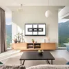 A modern living room with a TV mounted on the wall above a wooden media console. Anteprima dell’immagine prodotto