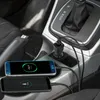 Two smartphones charging in a car's center console using a car charger. Náhled obrázku produktu
