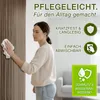 A woman is cleaning a wooden slat wall with a cloth, highlighting the product's easy maintenance features. Produktbild-Vorschau