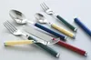 A collection of cutlery with colored handles arranged on a white surface. Produktbild-Vorschau
