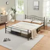 A bedroom scene with a metal bed frame, bedding, a dresser, a plant, and a clock on the wall. Voir les images du produit