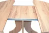 A close-up view of an extendable wooden dining table. Produktbild-Vorschau