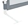 A close-up view of a white and gray bed rail support. Voir les images du produit