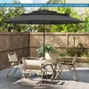 A patio set with a large umbrella, table, and chairs on a wooden deck. Náhled obrázku produktu