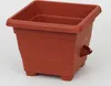 A terracotta-colored plastic planter pot with a built-in watering system is shown against a white background. Produktbild-Vorschau