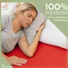 A woman sleeping on a bed with a pillow. Produktbild-Vorschau