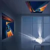 A room with a projector displaying images on the wall and ceiling. Náhled obrázku produktu