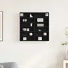A black display cabinet mounted on a white wall, filled with various decorative items. Produktbild-Vorschau
