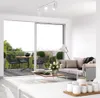 A modern living room with a balcony view, featuring a sofa, coffee table, and a ceiling light. Produktbild-Vorschau