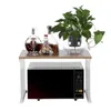 A microwave stand with items on top. Voir les images du produit