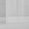 A close-up view of a white, three-panel shower screen for a bathtub, with a frosted plastic finish and vertical lines. Anteprima dell’immagine prodotto