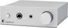 A silver headphone amplifier with a large volume knob and two headphone jacks on the front panel. Produktbild-Vorschau