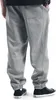 A person wearing grey sweatpants and black sneakers. Produktbild-Vorschau