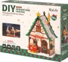 The image shows the packaging of a DIY miniature Christmas house kit. The packaging features a prominent image of the assembled house, along with product details and branding. Produktbild-Vorschau