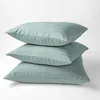 Three mint green striped pillows stacked on a white background. Náhled obrázku produktu