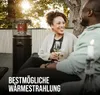 A couple enjoying a warm evening outdoors with a patio heater. Produktbild-Vorschau