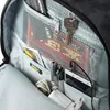 Close-up view of the interior of a backpack, showing various items organized in pockets. Produktbild-Vorschau