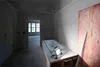 A bathroom under construction with a bathtub and insulation visible. Anteprima dell’immagine prodotto