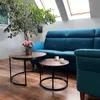 A living room scene with a couch, coffee tables, and a plant. Produktbild-Vorschau