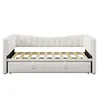 A white upholstered daybed with a pull-out trundle bed underneath, shown from the front with the mattress slats visible. Anteprima dell’immagine prodotto
