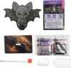 A collage of items related to a diamond painting kit, including the main bat-shaped item, a fact card, a decorative backing, and bags of colored beads. Náhled obrázku produktu