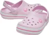 A pair of light pink Crocs with white and pink stripes on the sole, shown from a slightly elevated angle against a white background. Podgląd zdjęcia produktu
