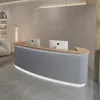A modern reception desk with two computer monitors in a clean, minimalist interior. Produktbild-Vorschau